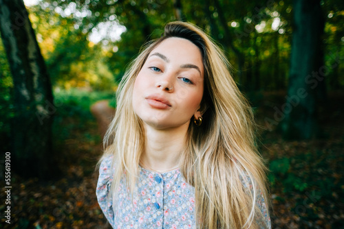 Portrait of attractive caucasian woman posing in the autumn park.
