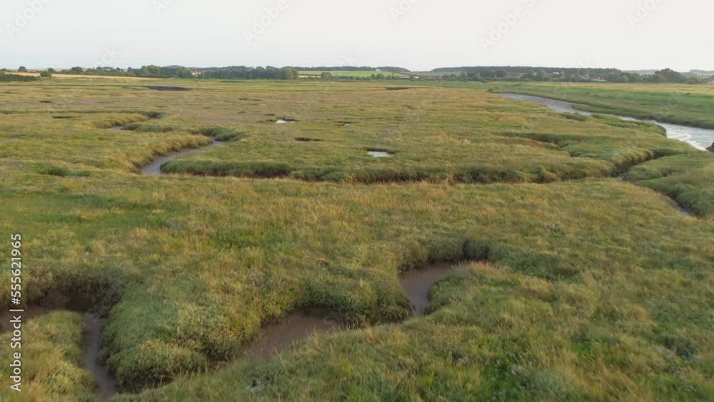 Low Aerial Drone Shot Flying Over Fairly Dry Green Salt Marsh at Sunset in North Norfolk UK Low Aerial Drone Shot Flying Over Fairly Dry Green Salt Marsh at Sunset in North Norfolk UK