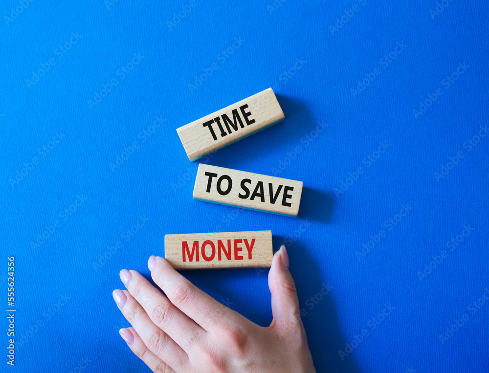 Time to save money symbol. Wooden blocks with words Time to save money. Businessman hand. Beautiful blue background. Business and Time to save money concept. Copy space. Time to save money symbol. Wooden blocks with words Time to save money. Businessman hand. Beautiful blue background. Business and Time to save money concept. Copy space.