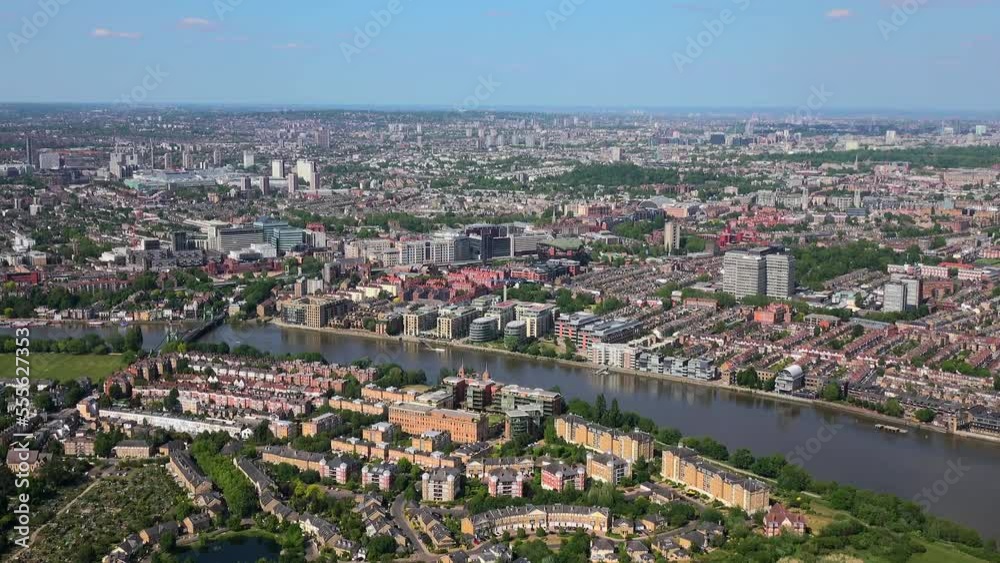 Aerial view of Hammersmith bridge over the Thames, with Hammersmith behind, panning to the City of London. Hammersmith, London, UK. Aerial view of Hammersmith bridge over the Thames, with Hammersmith behind, panning to the City of London. Hammersmith, London, UK.