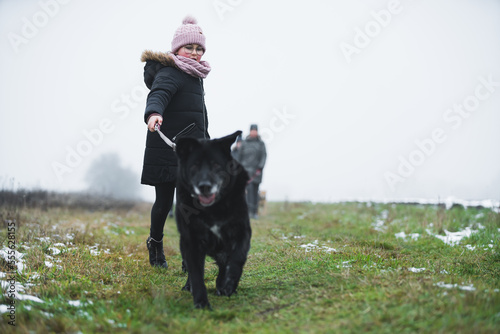 Little girl walking a dog in nature. High quality photo © PoppyPix