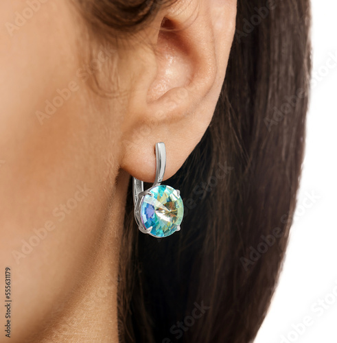 Isolated earrings with a large sparkling crystal on a white background. Luxurious jewelry for the catalog. Advertising photo for a jewelry store website