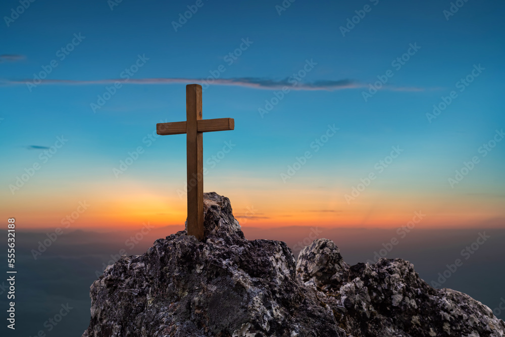 Christian cross on top rock mountain colorful sky background. Christian background concept