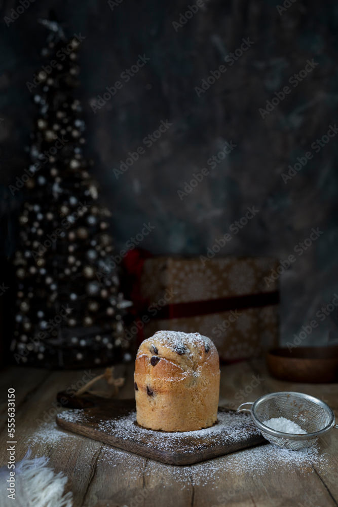 Cupcake sprinkled with powdered sugar on a rustic table Cupcake sprinkled with powdered sugar on a rustic table