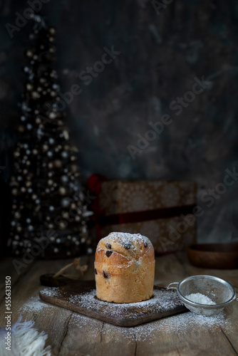 Cupcake sprinkled with powdered sugar on a rustic table