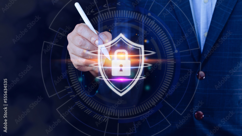 Naklejka premium Computer network protection, secure and safe your data concept, businessman holding shield protection icon, Security shield Lock Security Businessman Protect Concept