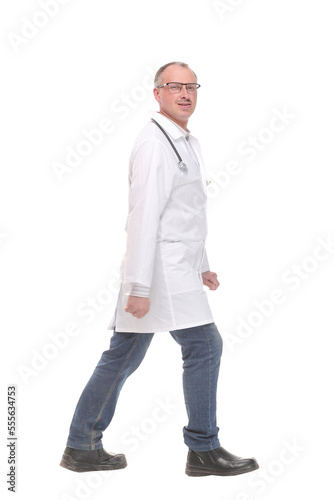 Middle age doctor with stethoscope walking on white background
