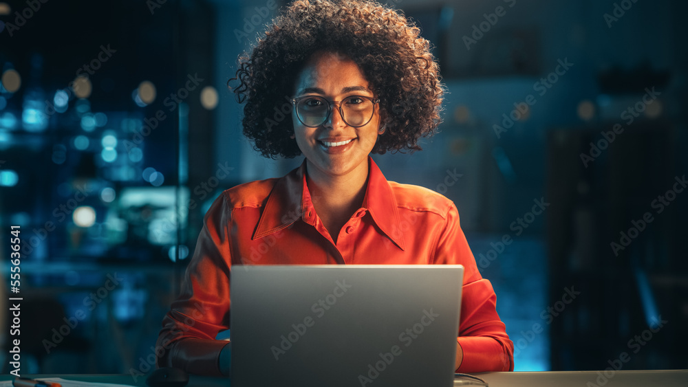 Beautiful Multiethnic Brazilian Female Working on Laptop Computer Late at Night. Young Creative Manager Feeling Happy, Looking at Camera and Smiling. Zoom In Portrait Footage. - obrazy, fototapety, plakaty 