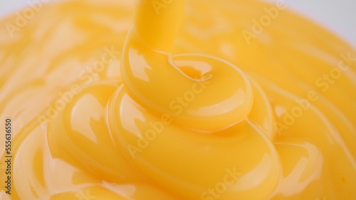Pour yellow cheese sauce close up
