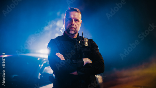 Schilderij op canvas Portrait of Professional Caucasian Male Police Officer Crossing His Arms, Posing, Looking at the Camera