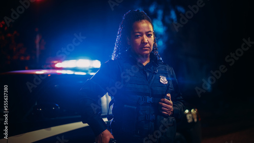 Professional Blaсk Female Police Officer Looking at the Camera. Policewoman Maintains public order and safety, Enforcing the Law, Prevents and Investigates Criminal Activity. Cinematic Portrait