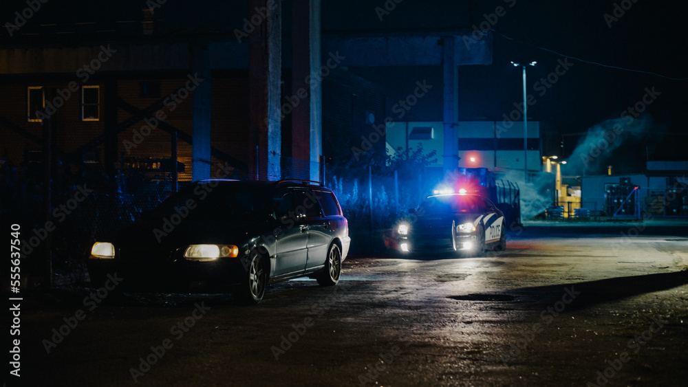 Highway Traffic Patrol Car In Pursuit of Criminal Vehicle, Traffic Stop, Pull Over, Arrest. Police Officer Gets out of Squad Car, Approaches Suspect. Cinematic Action in Industrial Urban Area at Night