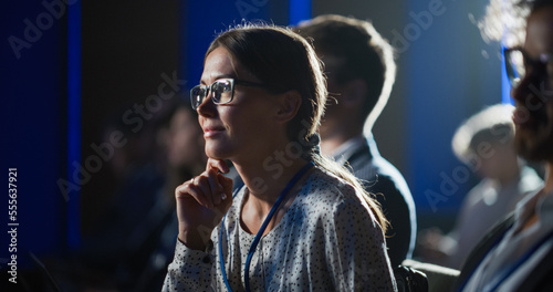 Konstfotografi Close up Portrait of Young Enthusiastic Female Attending a Motivational Speaker Event, Sitting in a Crowded Concert Hall, Leaning Closer to the Stage and Listening Carefully to the Presentation