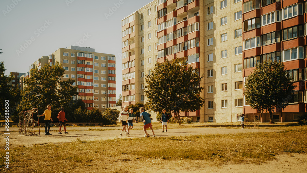 Neighborhood Kids Playing Soccer in the Hood. Young Football Player Dribbling and Scoring a Fascinating Goal. Boys and Girls High Five, Celebrate the Victory.