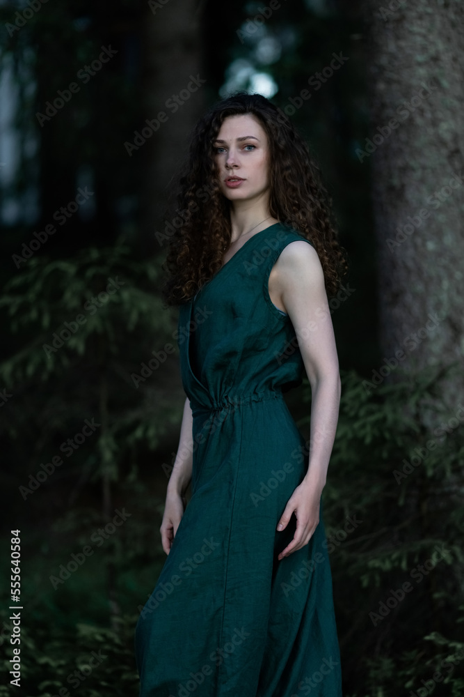 Young, beautiful skinny brunette posing in a forest grove. Young country girl in a classic sundress Young, beautiful skinny brunette posing in a forest grove. Young country girl in a classic sundress