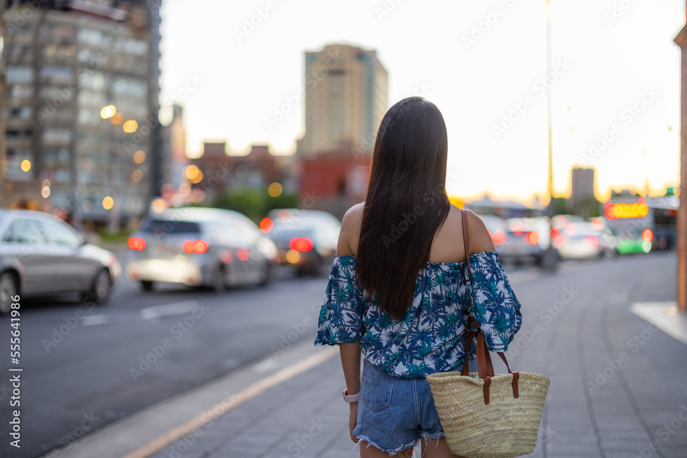 Woman in the Taipei city street in the evening