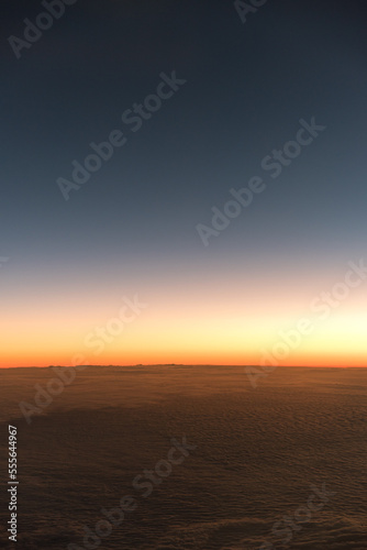 Sunset above the clouds from airplane