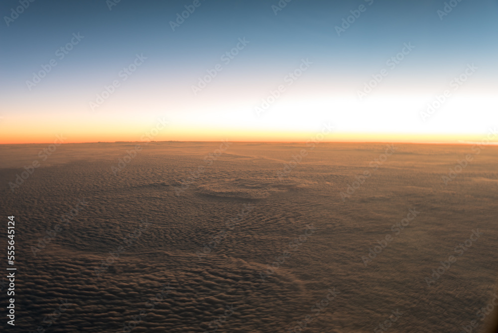 Sunset above the clouds from airplane