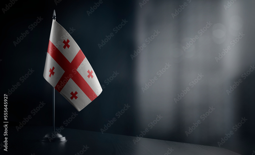Small national flag of the Georgia on a black background