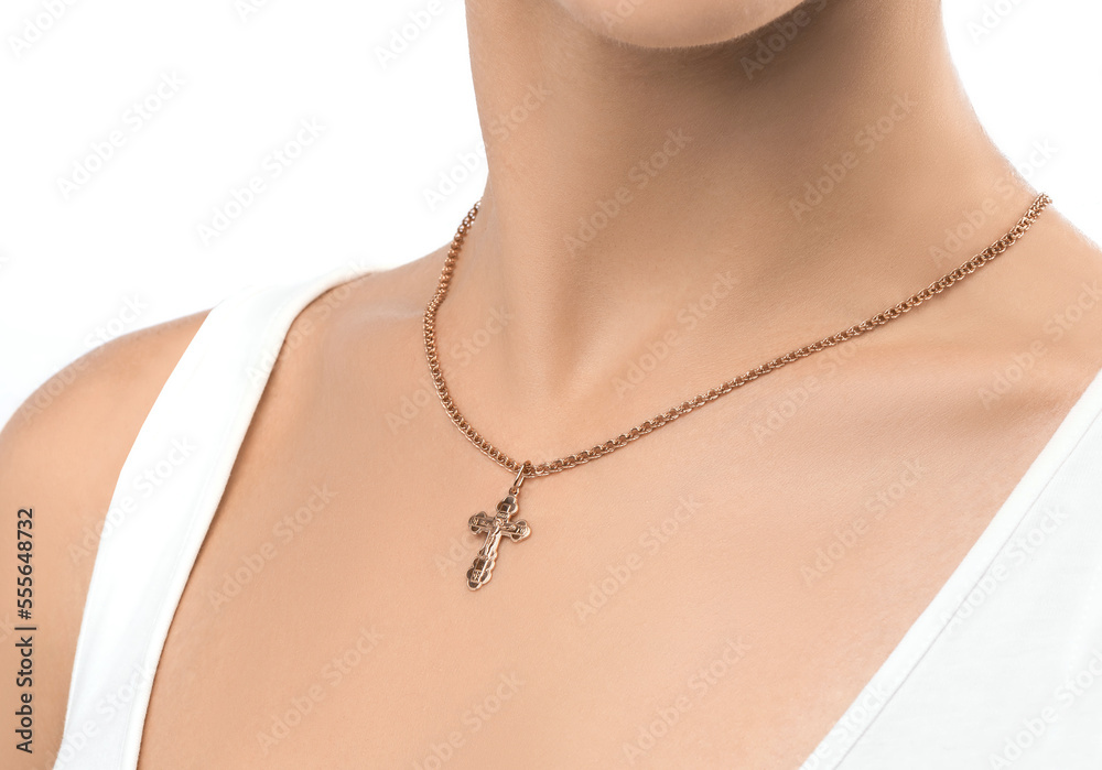 isolated on white background jewelry silver cross on a golden chain around the neck of a model girl. Front and side view of jewelry on girl