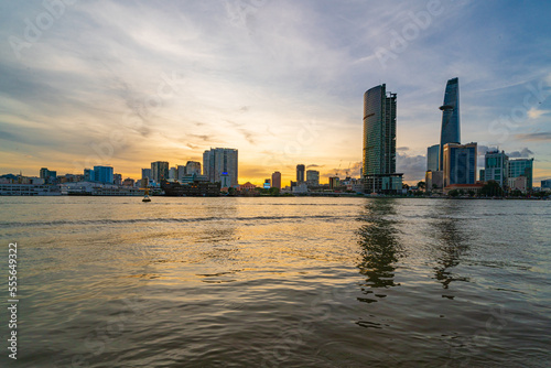 Ho Chi Minh City skyline and the Saigon River at sunset. Amazing colorful view of skyscraper and other modern buildings. Travel concept © Quang Ho