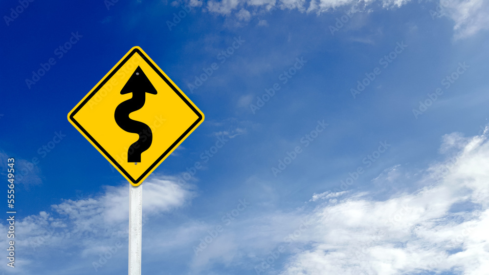 Yellow warn sign with switchback arrow starting from the right on blue sky background Yellow warn sign with switchback arrow starting from the right on blue sky background