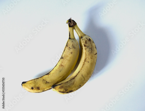 Two yellow bananas on a white background