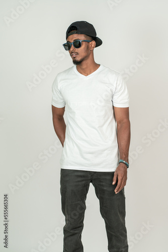 An african man with blank white v-neck shirt doing a pose the white background