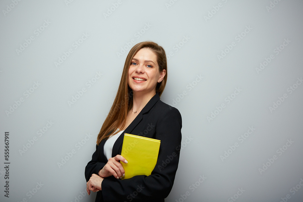 Student woman holding book. Girl in black suit. Isolated portrait with copy space. Student woman holding book. Girl in black suit. Isolated portrait with copy space.