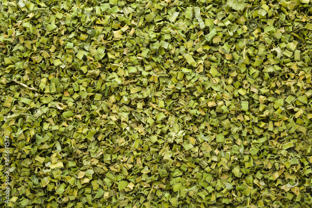 Dry green onions background. Closeup. Healthy spice for food. Top down view.