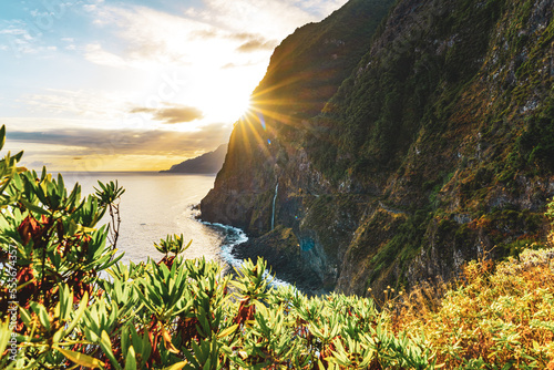 Waterfall flowing into the sea in a picturesque morning atmosphere. Viewpoint Véu da Noiva, Madeira Island, Portugal, Europe. photo