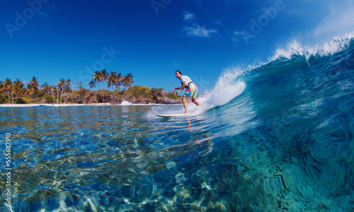 Man surf the ocean wave in tropics