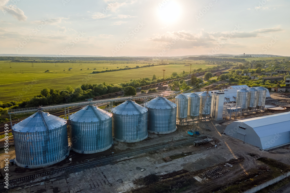 Aerial view of industrial ventilated silos for long term storage of grain and oilseed. Metal elevator for wheat drying in agricultural zone