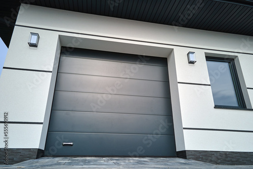 Automatic electric roll-up commercial garage gate or push-up door in modern private building ground floor photo