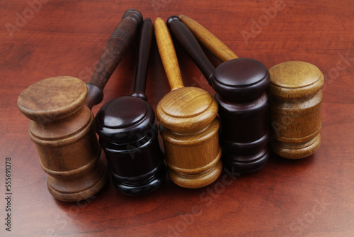 Close up of different judge gavel on wooden table. Different laws, courts and legal systems concept.