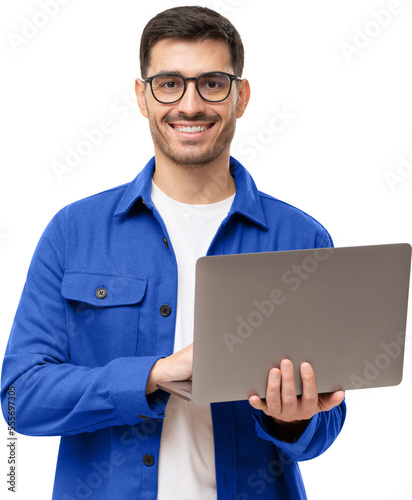 Studio portrait of young man standing holding laptop and looking at camera with happy smile