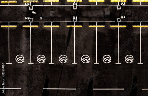 Aerial view directly above electric car charging station sign at a parking lot