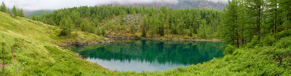 Kuektanar lake in the forest , in Altai