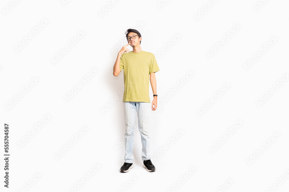 Fototapeta premium Single skinny young male. The full body of an Asian or Indonesian person. Isolated photo studio with white background.