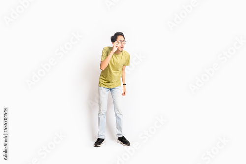 Single skinny young male. The full body of an Asian or Indonesian person. Isolated photo studio with white background. © masb2t