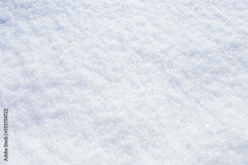 snow background. Snowflakes sparkle on the white surface of the snow