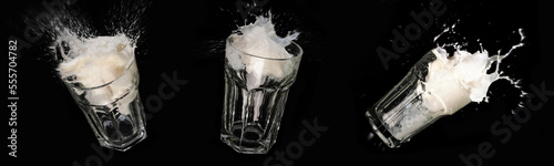 schizzi di latte sui bicchieri di vetro su sfondo nero photo