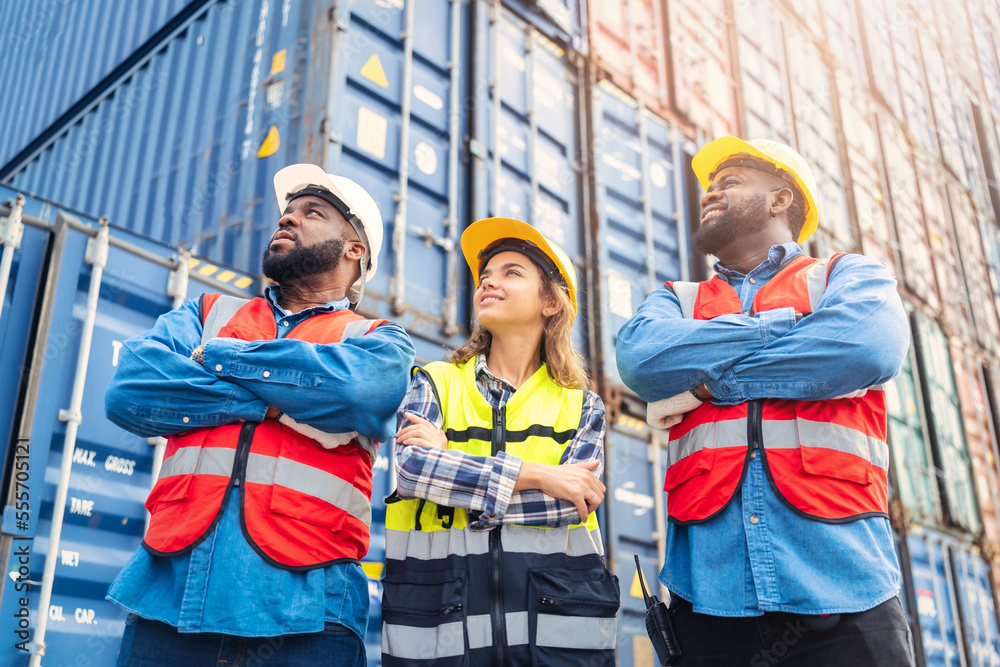 Portrait of Engineer or foreman team pointing up the future with cargo container background at sunset. Logistics global import or export shipping industrial concept. Portrait of Engineer or foreman team pointing up the future with cargo container background at sunset. Logistics global import or export shipping industrial concept.