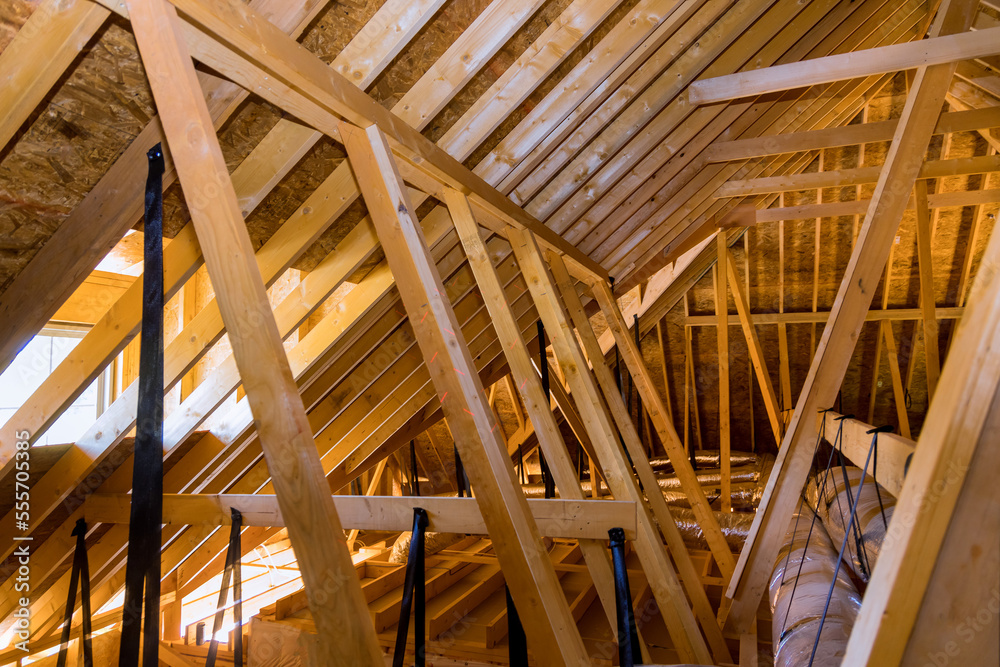 Obraz premium Ventilation pipes in silver insulation material on ceiling inside newly built home under construction