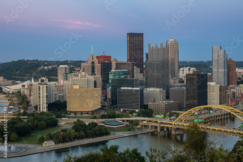 Cityscape of Pittsburgh and Evening Light. Fort Pitt Bridge. Blurry Ferry Cruise in Background Because of Long Exposure. Selective focus.