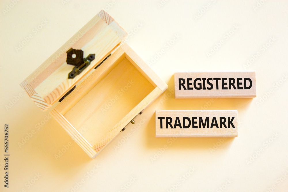Registered trademark symbol. Concept word Registered trademark on wooden blocks. Beautiful white table white background. Empty wooden chest. Business and registered trademark concept. Copy space. Registered trademark symbol. Concept word Registered trademark on wooden blocks. Beautiful white table white background. Empty wooden chest. Business and registered trademark concept. Copy space.