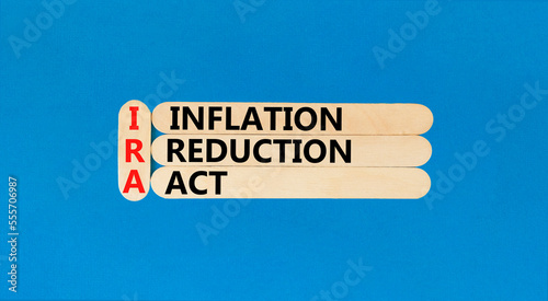 IRA inflation reduction act symbol. Concept words IRA inflation reduction act on wooden sticks on beautiful blue table blue background. Business IRA inflation reduction act concept. Copy space. photo