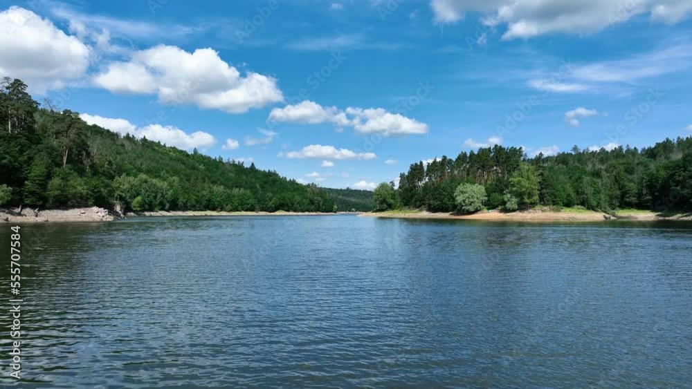 Fly over water surface of majestic flooded dam, rocky cliffs, beaches and islands Fly over water surface of majestic flooded dam, rocky cliffs, beaches and islands