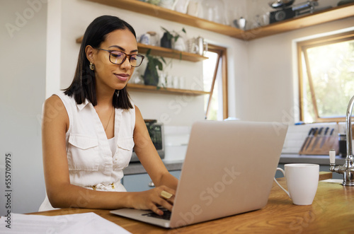 Remote work, busines woman and use laptop for typing, planning for startup company and strategy for finance. Entrepreneur, digital device or work from home being focus, thinking or writer copywriting photo