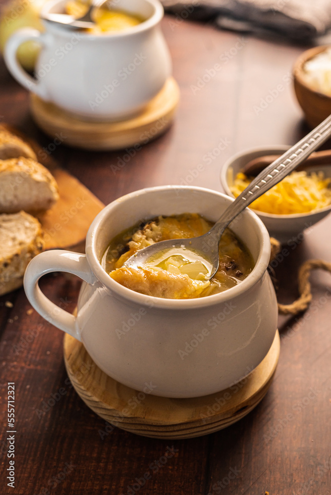 homemade onion soup on a wooden table homemade onion soup on a wooden table